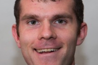 Headshot of Tom McCoy
