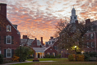 New England brick buildings in front of a sunset