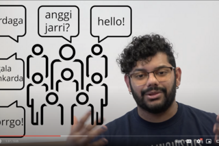 Screenshot of video. Icons of people are shown with speech bubbles in Barrdi and English.